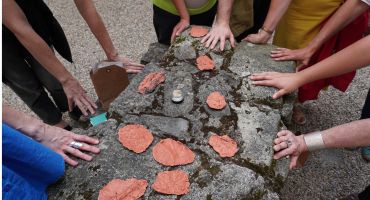 Hands touching a rock